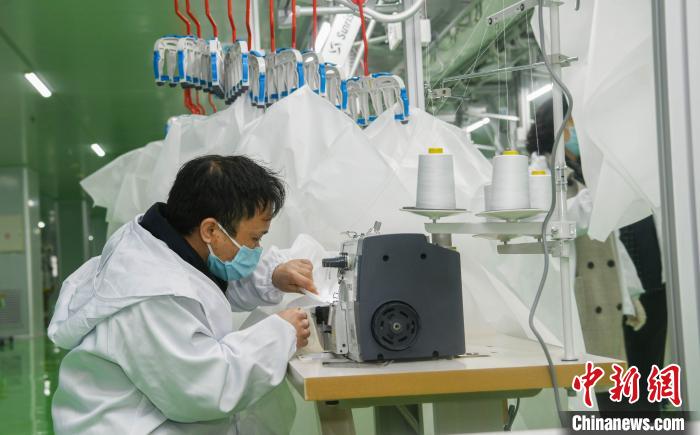 工人生產(chǎn)防護(hù)服，保障抗疫物資供應(yīng)。廣安市委宣傳部供圖
